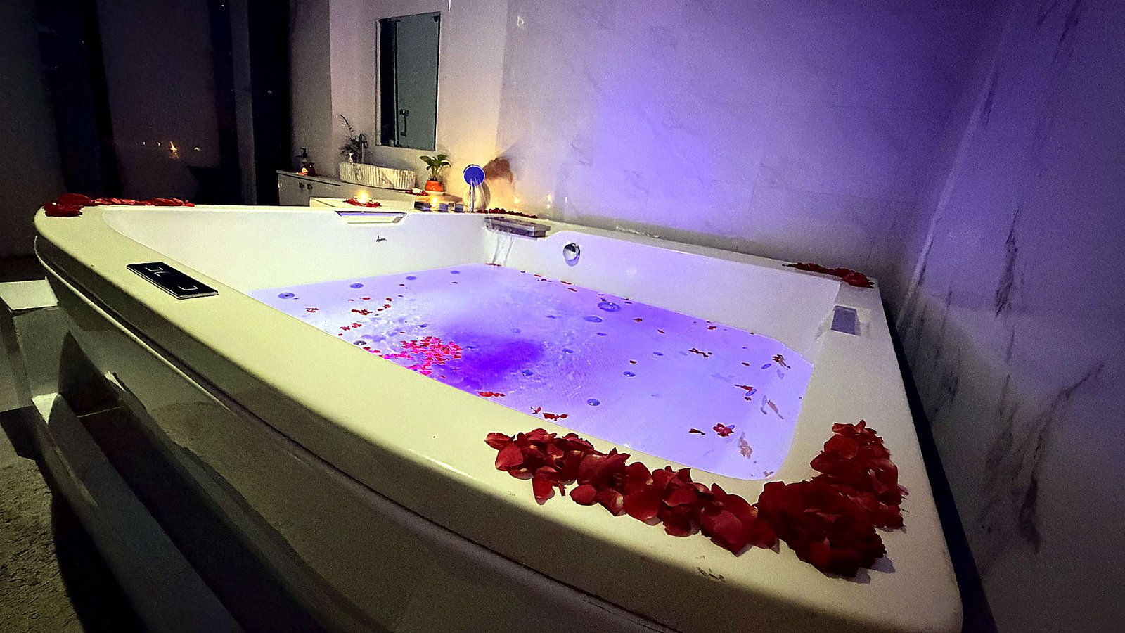 Couple jacuzzi suite with rose petals and mood lighting at Vaayu Wellness Spa
